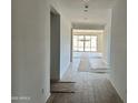 Hallway leading to sliding glass doors and a bright, spacious room with tile flooring at 5510 W Paseo Way, Laveen, AZ 85339