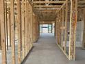 A spacious interior under construction, featuring wood framing and an open floor plan with visible utilities at 5510 W Paseo Way, Laveen, AZ 85339
