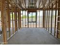Framed interior space with large window views, showcasing natural light and construction readiness at 5510 W Paseo Way, Laveen, AZ 85339