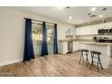 Bright kitchen with island and sliding door to backyard at 728 E Payton St, San Tan Valley, AZ 85140