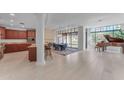 Open kitchen with granite countertops, dark wood cabinets, and island at 8 E Biltmore Est # 117, Phoenix, AZ 85016