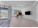 Bright living room with hardwood floors, grand piano, and large windows at 8 E Biltmore Est # 117, Phoenix, AZ 85016