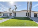 Attractive exterior with a glass garage door and a well-maintained lawn at 8525 E Via De Los Libros --, Scottsdale, AZ 85258