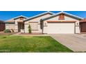One-story house with a two-car garage and a green lawn at 14533 N 147Th Dr, Surprise, AZ 85379