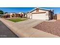 One story house with a two-car garage and landscaped yard at 14533 N 147Th Dr, Surprise, AZ 85379
