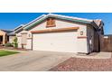 One-story house with a two-car garage and desert landscaping at 14533 N 147Th Dr, Surprise, AZ 85379