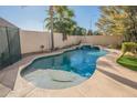 Inviting kidney-shaped pool with a waterfall feature at 1491 W Armstrong Way, Chandler, AZ 85286