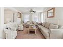 Cozy living room with light colored couches and a wooden coffee table at 22194 N Kingston Dr, Maricopa, AZ 85138