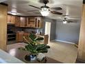 Spacious kitchen with light wood cabinets, stainless steel appliances, and tile flooring at 3539 W Davidson Ln, Phoenix, AZ 85051