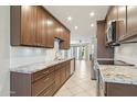 Well-lit kitchen features stainless steel appliances, granite countertops and ample cabinet space with tile floors at 5998 N 78Th St # 116, Scottsdale, AZ 85250