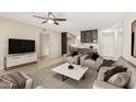 Comfortable living room with plush seating, a modern entertainment center, and an open view to the kitchen at 5998 N 78Th St # 116, Scottsdale, AZ 85250