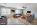 Bright living room featuring tile flooring, plantation shutters, modern furnishings, and plenty of natural light at 7519 N 23Rd Ave, Phoenix, AZ 85021