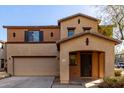 Inviting two-story home features a covered porch and attached two-car garage at 18409 W Dawn Dr, Surprise, AZ 85374