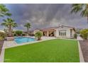 Luxury home with a spacious backyard, pool, and lush landscaping at 32159 N 127Th Dr, Peoria, AZ 85383
