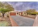 Single-story home with desert landscaping and a large driveway at 32159 N 127Th Dr, Peoria, AZ 85383