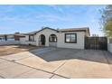 Updated single story home with a modern design, arched entryway and a large driveway at 6807 W Colter St, Glendale, AZ 85303