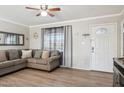 Bright and airy living room featuring a comfortable sectional sofa and wood-look floors at 6807 W Colter St, Glendale, AZ 85303