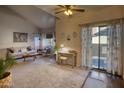 Bright living room featuring high ceilings, a modern couch, and a sliding glass door with natural light at 930 N Mesa Dr # 2073, Mesa, AZ 85201