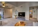 Inviting living room with a large TV, comfortable seating, and easy access to the bathroom at 930 N Mesa Dr # 2073, Mesa, AZ 85201