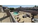 Enjoy outdoor living with a sparkling pool, built-in grill, and lounge area in the backyard at 11232 N 152Nd Ln, Surprise, AZ 85379