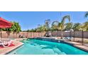 Inviting swimming pool with a spacious deck and backyard at 11232 N 152Nd Ln, Surprise, AZ 85379