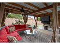 Covered patio with comfortable seating and a large TV at 14415 N 62Nd St, Scottsdale, AZ 85254