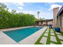 Relaxing rectangular pool, surrounded by artificial turf and stone at 14415 N 62Nd St, Scottsdale, AZ 85254