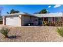 House exterior showcasing a well-maintained front yard and garage at 14818 N 103Rd Ave, Sun City, AZ 85351