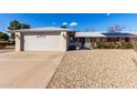 Front view of a single-story house with a two-car garage at 14818 N 103Rd Ave, Sun City, AZ 85351