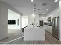 Modern kitchen with a large island and stainless steel appliances at 1553 N 69Th Pl, Scottsdale, AZ 85257