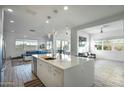 Spacious kitchen with white cabinetry, island, and modern appliances at 1553 N 69Th Pl, Scottsdale, AZ 85257