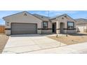 Beautiful one-story home with a two-car garage, a welcoming front entrance and a low-maintenance front yard at 1561 E Mason Dr, Casa Grande, AZ 85122