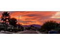 Community view showcasing beautiful sunset and mountain backdrop at 17561 N Saddle Ridge Dr, Surprise, AZ 85374