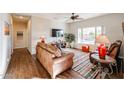 Spacious living room featuring leather furniture and hardwood floors at 17561 N Saddle Ridge Dr, Surprise, AZ 85374