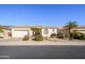 Single-story home with neutral exterior, landscaping, and a two-car garage at 17824 W Addie Ln, Surprise, AZ 85374
