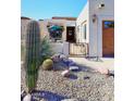 Landscaped front yard with cacti, gravel, and a gated entry to a charming home at 18658 E Mazatzal Cir, Rio Verde, AZ 85263