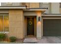 Modern house entrance with a dark-colored door and a wreath at 22124 N 34Th St, Phoenix, AZ 85050