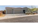 Single story house with a two-car garage and nicely landscaped front yard at 2476 N Abbey Rd, Casa Grande, AZ 85122