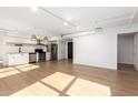 Open concept living area with hardwood floors and modern kitchen at 535 W Thomas Rd # 508, Phoenix, AZ 85013