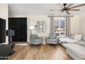 Light and airy living room with comfy seating and hardwood floors at 8375 E Indian School Rd, Scottsdale, AZ 85251