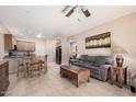 Open living room and kitchen with tile floors at 10960 E Monte Ave # 125, Mesa, AZ 85209