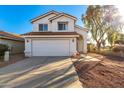 Two-story house with a white exterior, attached garage, and landscaping at 1203 E Muriel Dr, Phoenix, AZ 85022