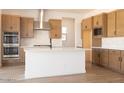 Modern kitchen boasts stainless steel appliances, an island with a white countertop and wooden cabinets at 1350 E Prescott St, Gilbert, AZ 85298