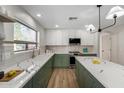 Modern kitchen with green cabinets, white countertops, and island at 1628 W San Tan Hills Dr, San Tan Valley, AZ 85144