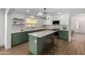 Modern kitchen with green cabinets, white countertops and island at 1628 W San Tan Hills Dr, San Tan Valley, AZ 85144