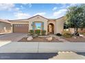 Single-story home with desert landscaping and a 2-car garage at 26573 W Abraham Ln, Buckeye, AZ 85396