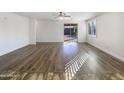 Spacious living area with wood-look flooring and sliding glass doors at 37803 W La Paz St, Maricopa, AZ 85138
