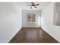 Empty spare bedroom with large window and tile flooring at 37855 W Merced St, Maricopa, AZ 85138