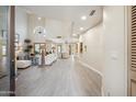 Bright, open-concept living room with high ceilings, modern furnishings, and seamless flow to the dining area at 6411 S River Dr # 10, Tempe, AZ 85283