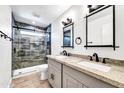 Updated bathroom with double vanity and a walk-in shower at 6427 W Turquoise Ave, Glendale, AZ 85302